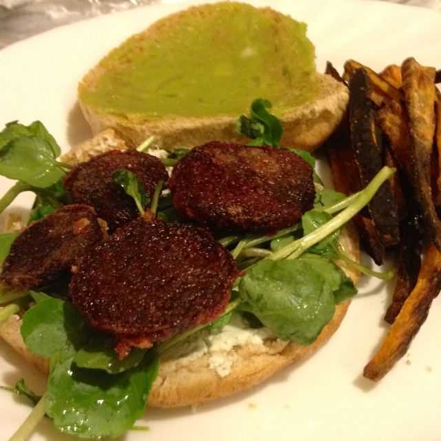Beet burger with goat cheese on a bed of arugula on a brioche bun